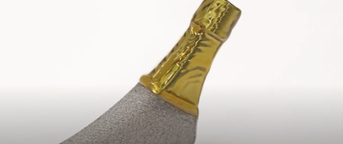 An orthopaedic implant with a surface covered in liquid mask adjacent to a blast-treated surface