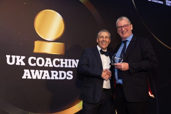 Darren Rea with xxx celebrating his win at the UK Coaching Awards.